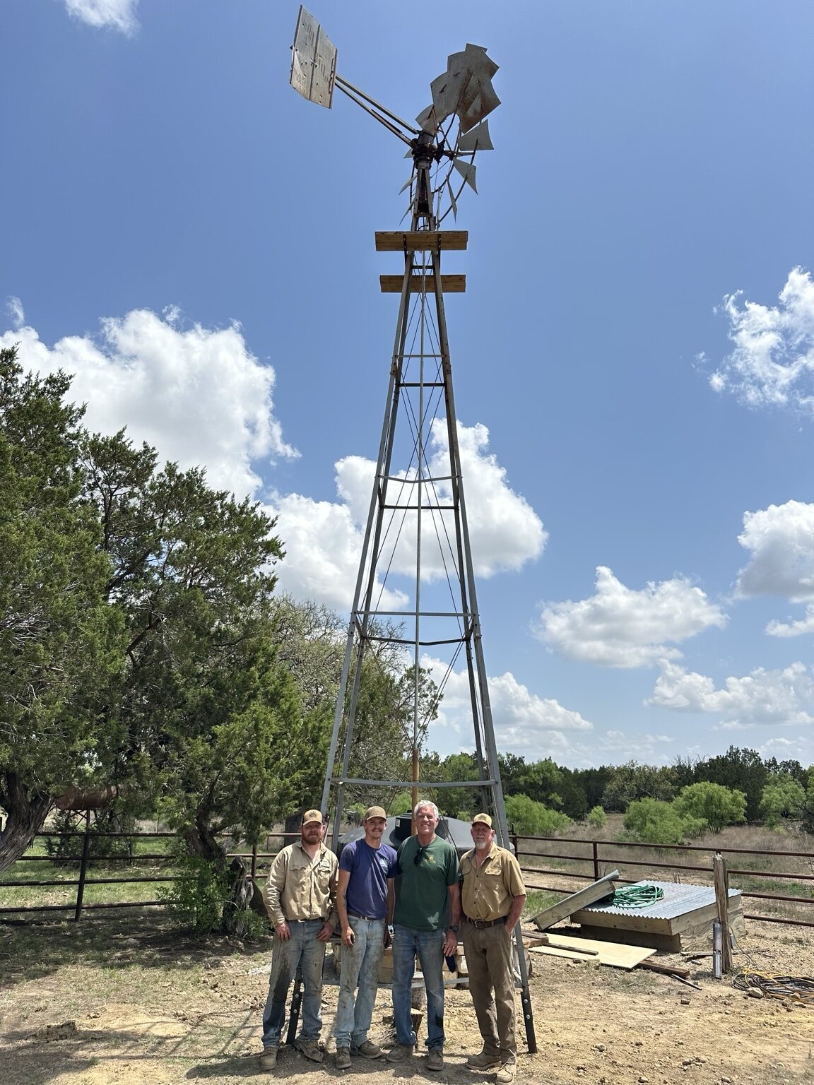 Concho Windmill crew gathered in front of a completed windmill project