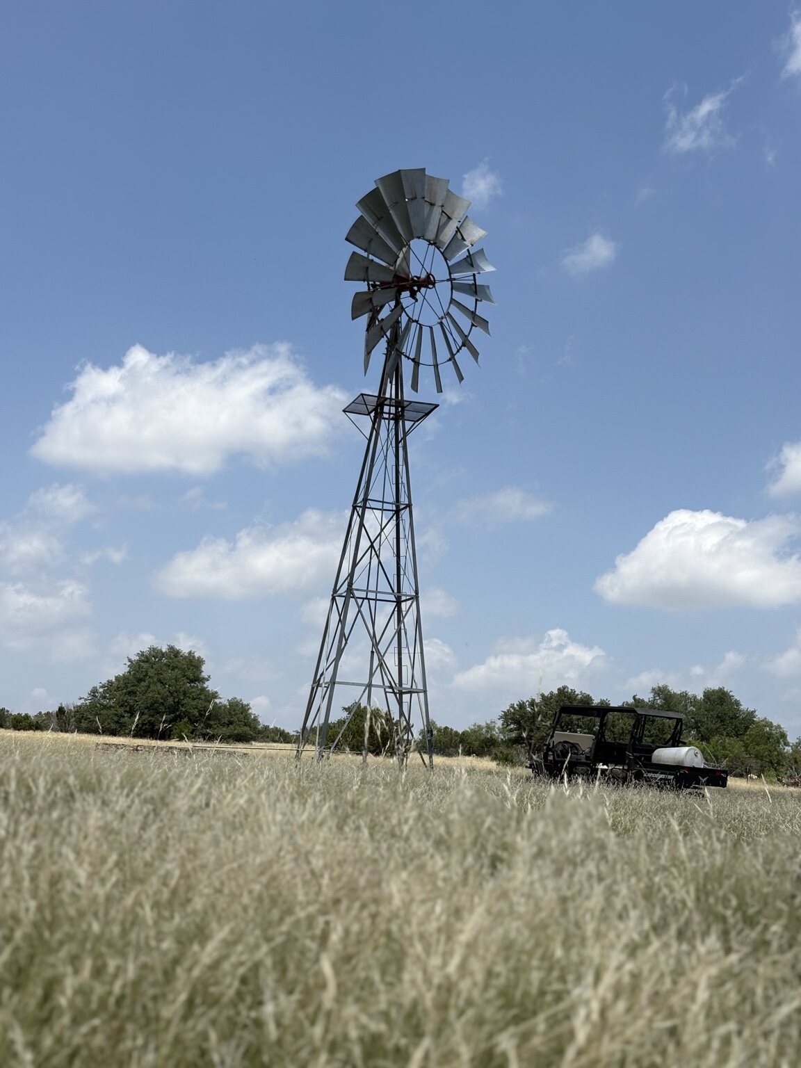 Completed windmill installation standing in Texas ranch grass