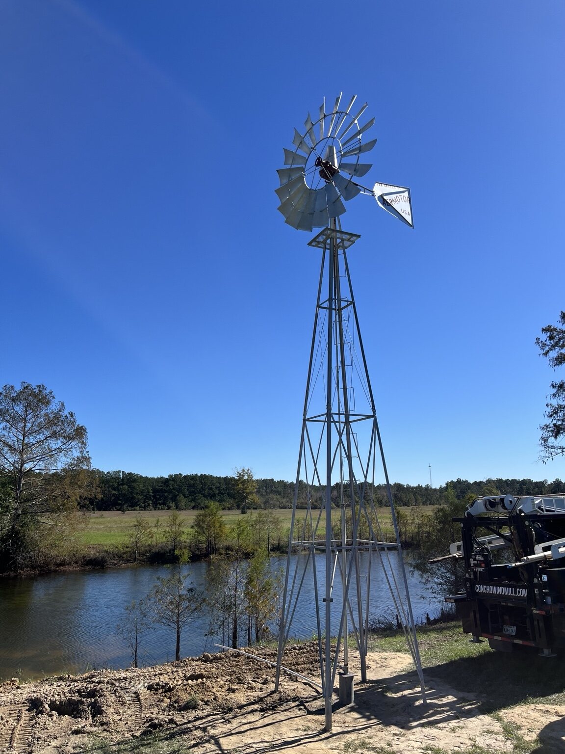 Windmill water system installed beside a ranch pond
